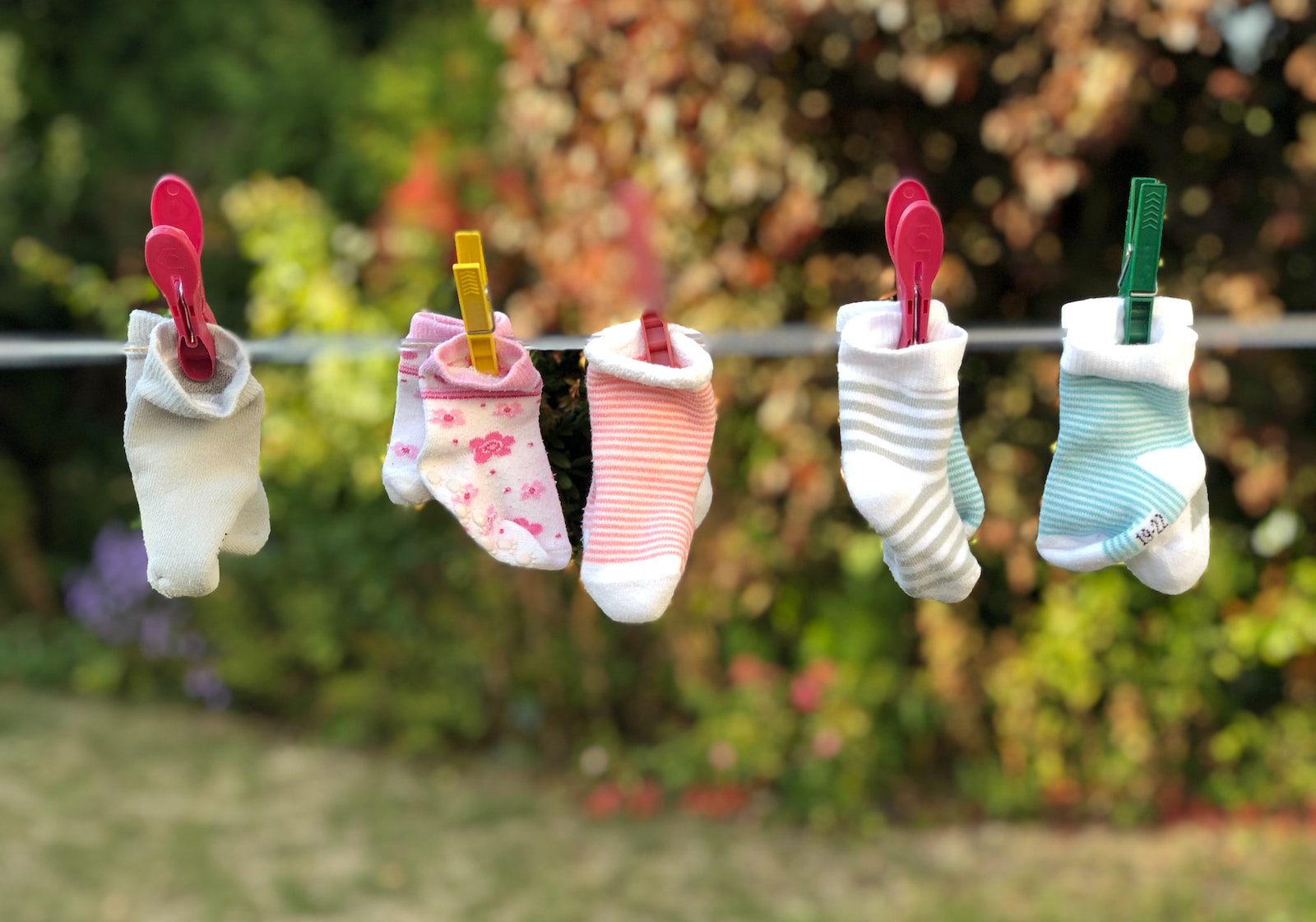 five pairs of socks pinned on clothesline